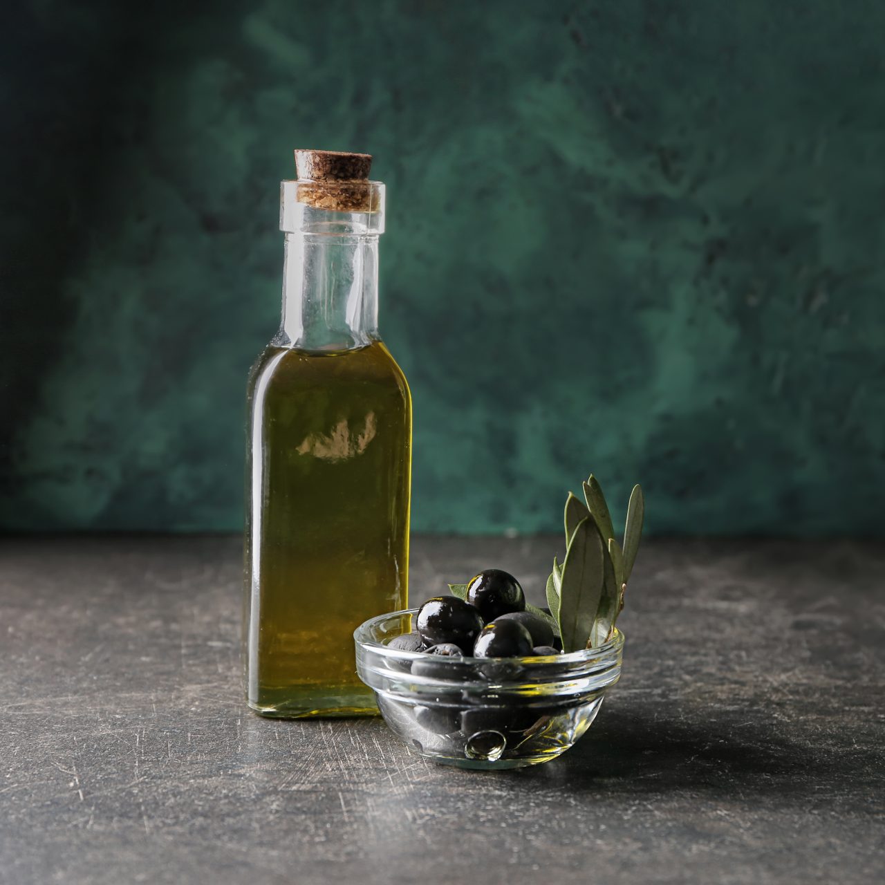 Bottle,With,Oil,And,Canned,Olives,On,Table
